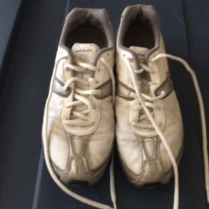 Silver white and gold Nike tennis shoes